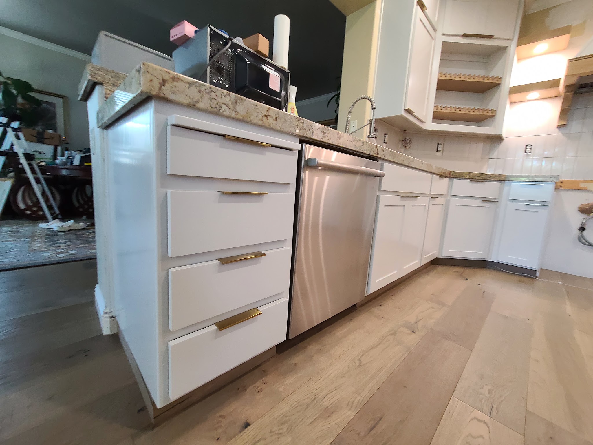 Refinished kitchen island with brass hardware